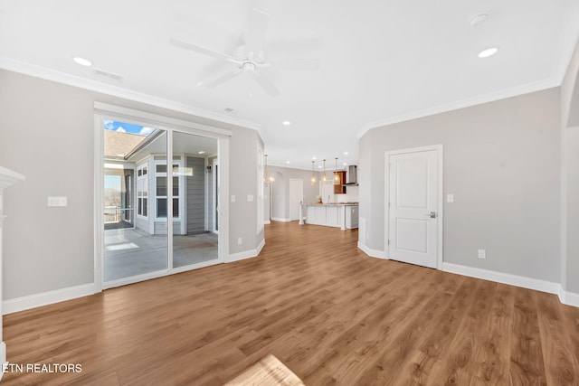 unfurnished living room with hardwood / wood-style flooring, ceiling fan, and crown molding