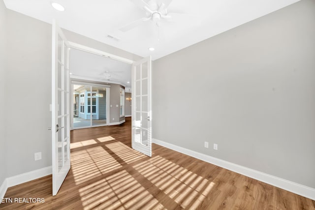 spare room with ceiling fan, french doors, and hardwood / wood-style floors