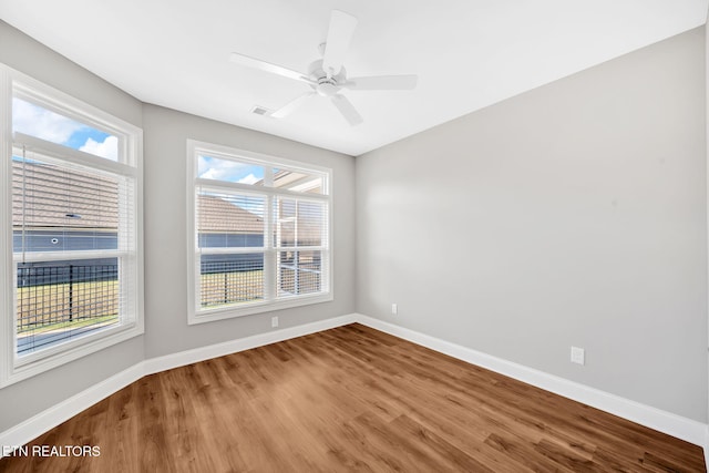 spare room featuring hardwood / wood-style flooring and ceiling fan