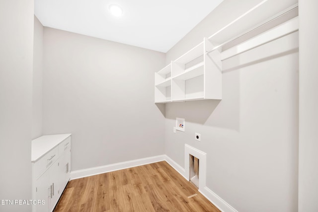 laundry area with washer hookup, electric dryer hookup, and light wood-type flooring