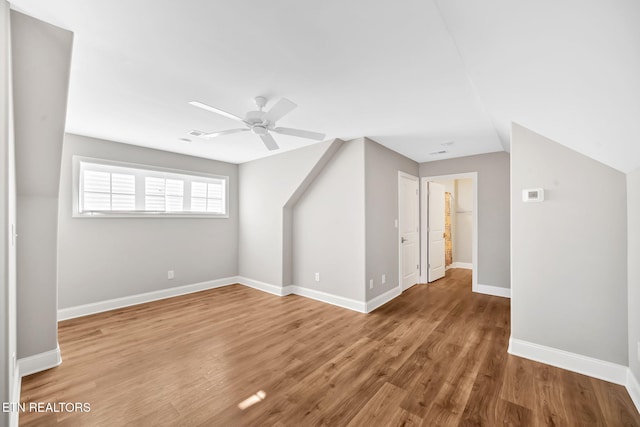 bonus room with ceiling fan, wood-type flooring, and vaulted ceiling