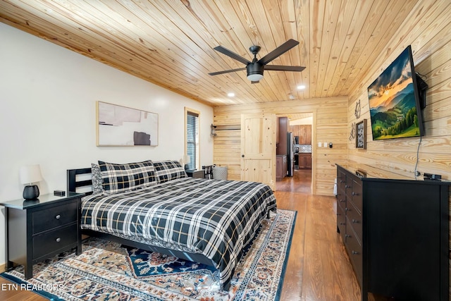 bedroom featuring wooden walls, ceiling fan, wood ceiling, and wood-type flooring