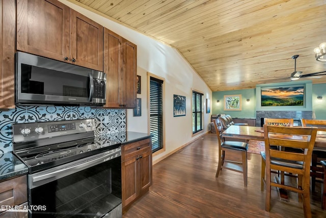 kitchen with dark wood-type flooring, vaulted ceiling, decorative backsplash, wood ceiling, and stainless steel appliances