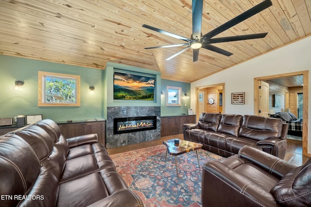 living room with ceiling fan, a premium fireplace, lofted ceiling, wood ceiling, and hardwood / wood-style flooring