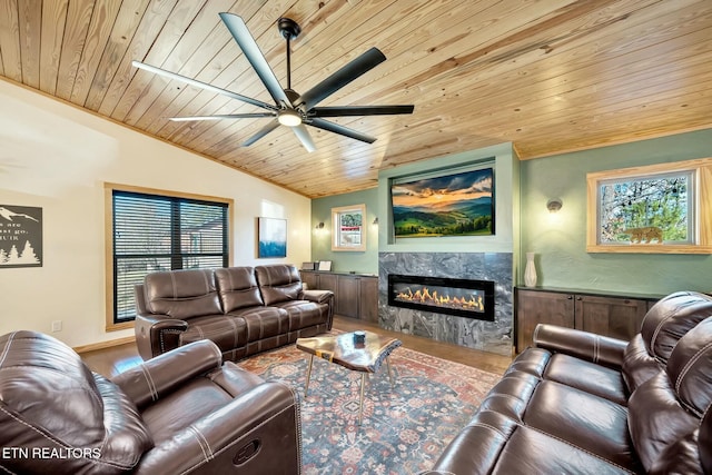 living room with hardwood / wood-style floors, lofted ceiling, wooden ceiling, a high end fireplace, and ceiling fan