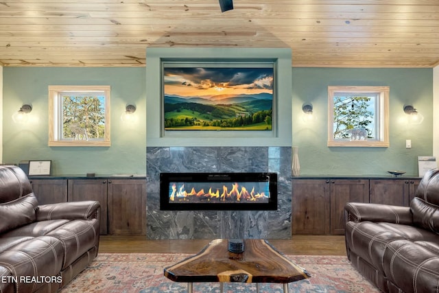 living room featuring a high end fireplace, light hardwood / wood-style floors, plenty of natural light, and wood ceiling