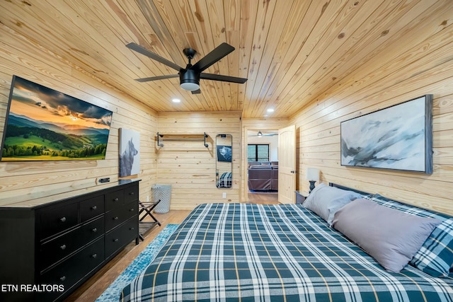 bedroom featuring wood walls, ceiling fan, light hardwood / wood-style floors, and wooden ceiling