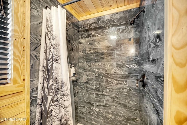 bathroom featuring curtained shower and wood ceiling