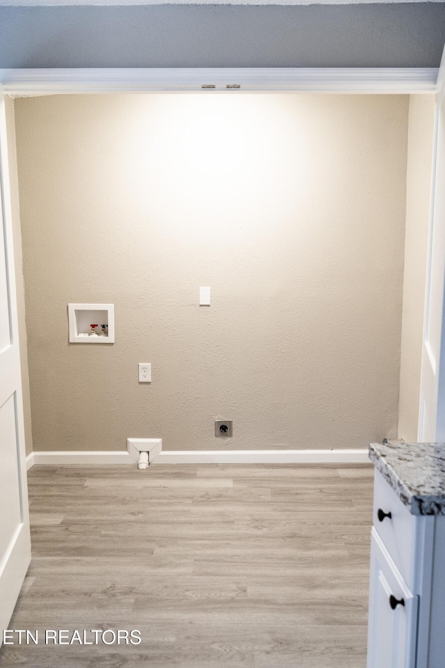 laundry area with washer hookup, electric dryer hookup, light wood-type flooring, and crown molding