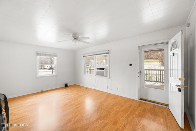 interior space featuring ceiling fan, light hardwood / wood-style floors, and cooling unit