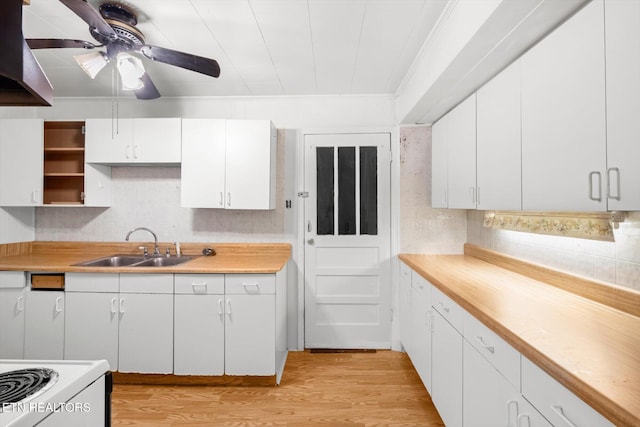 kitchen with ceiling fan, sink, white cabinets, and light hardwood / wood-style floors