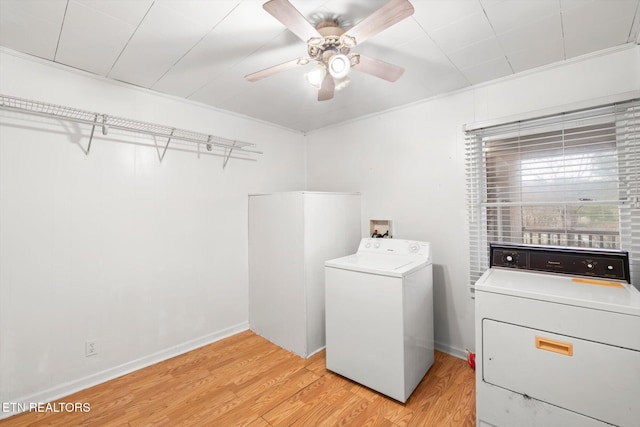 washroom with washer and clothes dryer, ceiling fan, light wood-type flooring, and crown molding