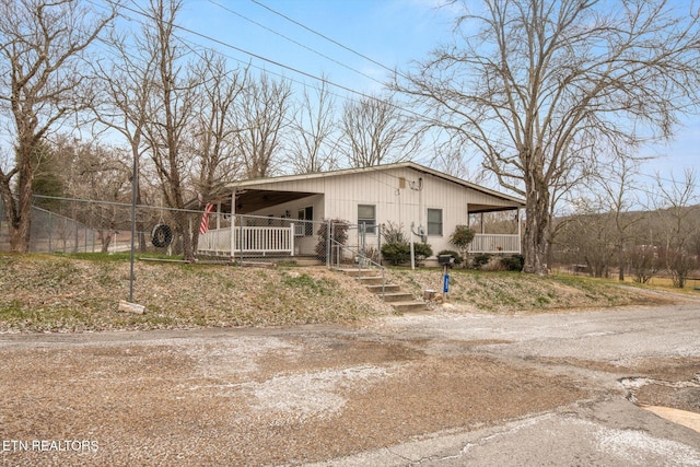 manufactured / mobile home with covered porch and a carport