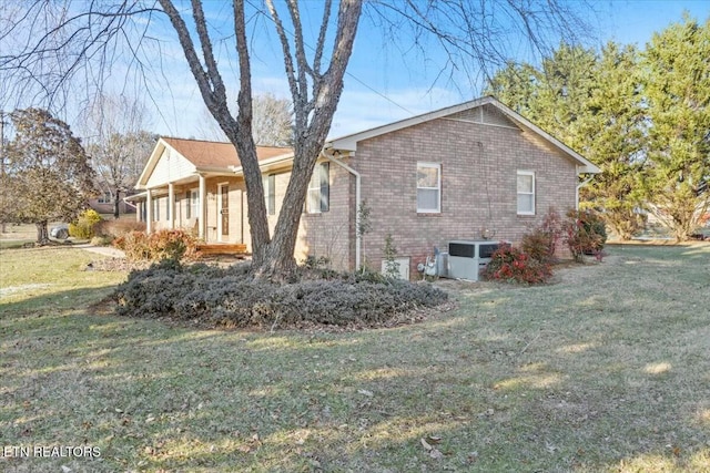 view of property exterior featuring a lawn and cooling unit