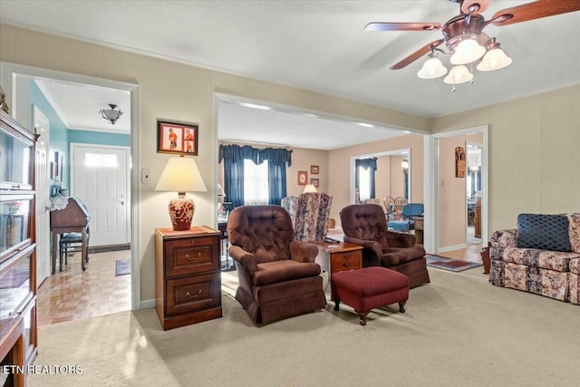 carpeted living room featuring ceiling fan