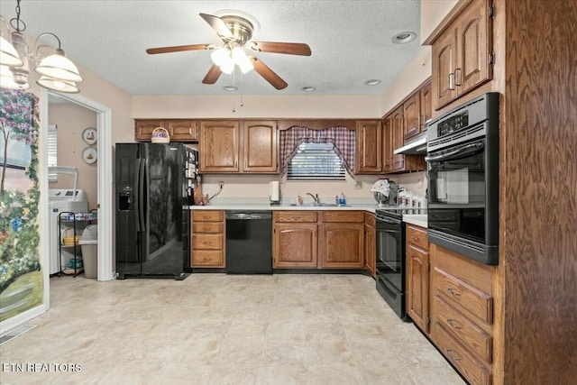 kitchen featuring hanging light fixtures, a textured ceiling, black appliances, ceiling fan with notable chandelier, and sink