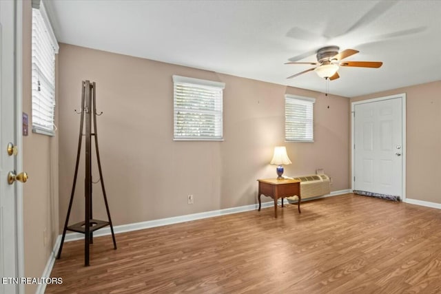 interior space with ceiling fan and light hardwood / wood-style flooring