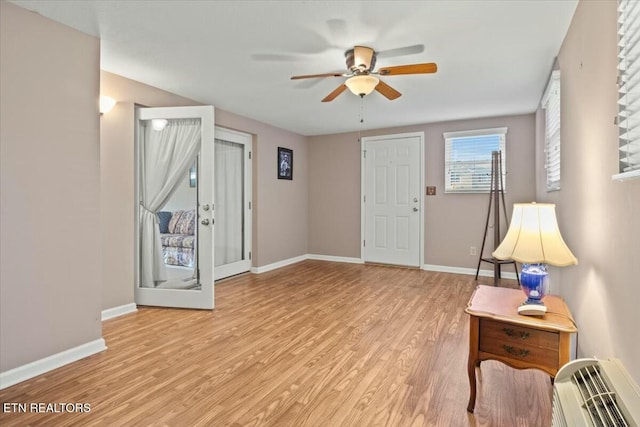 foyer with light hardwood / wood-style floors, french doors, and ceiling fan