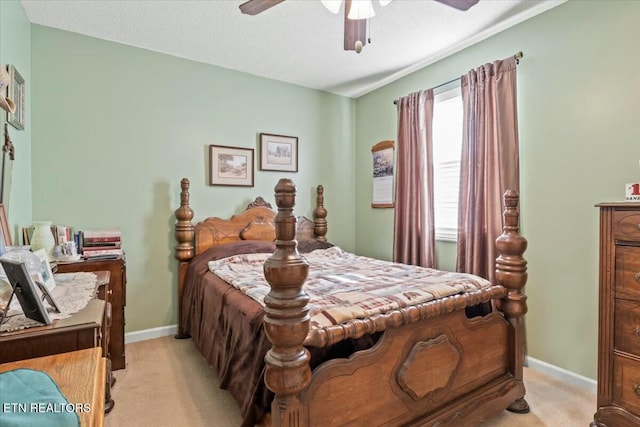 bedroom with light carpet, ceiling fan, and a textured ceiling