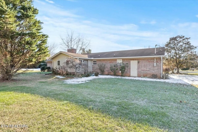 rear view of property with a yard