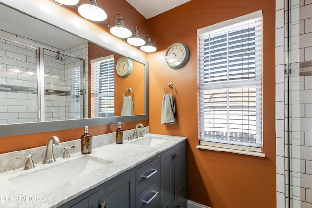 bathroom with a wealth of natural light, an enclosed shower, and vanity