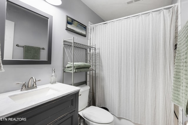 bathroom with toilet and vanity