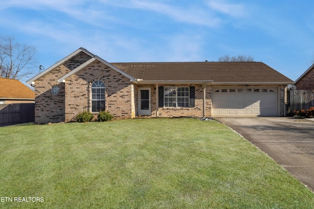 ranch-style home featuring a garage and a front lawn