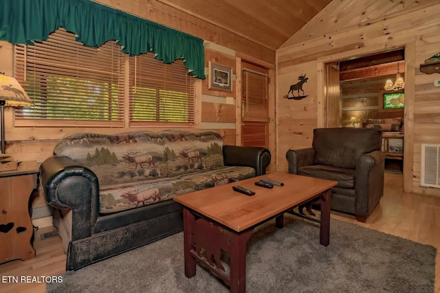 living room with vaulted ceiling, wooden walls, and wood ceiling