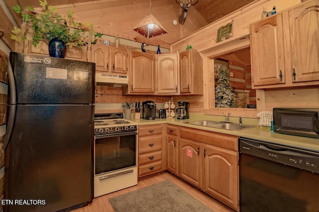 kitchen with black appliances, sink, light brown cabinetry, and vaulted ceiling