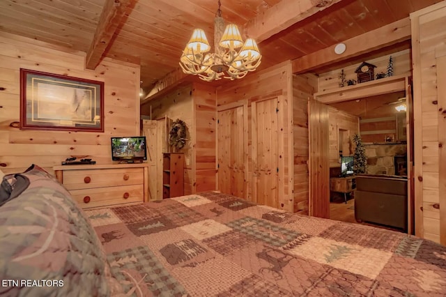 bedroom with a chandelier, beam ceiling, wooden walls, and wood ceiling