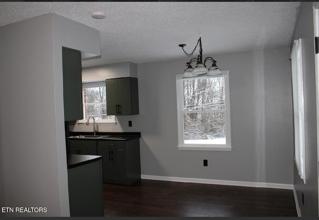 kitchen with a chandelier, sink, a textured ceiling, and a wealth of natural light