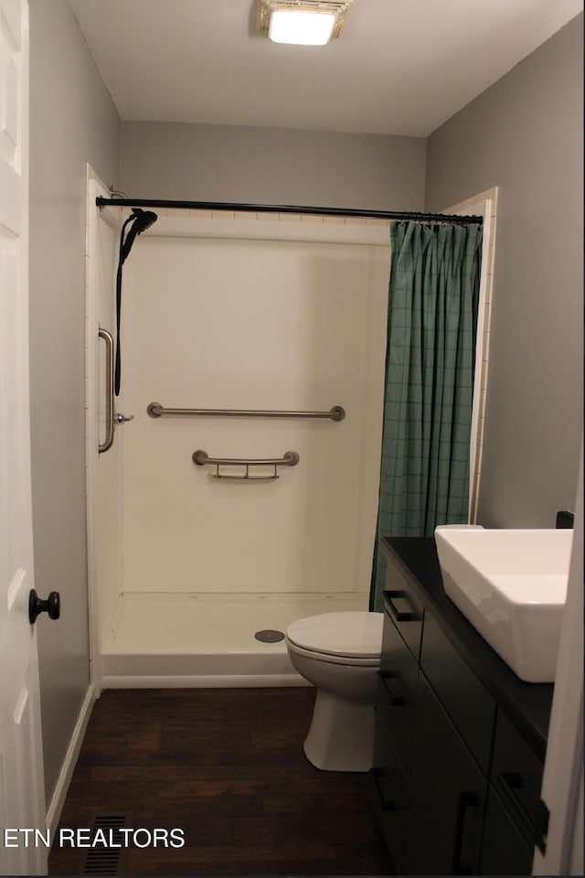 bathroom featuring hardwood / wood-style flooring, vanity, toilet, and a shower with shower curtain