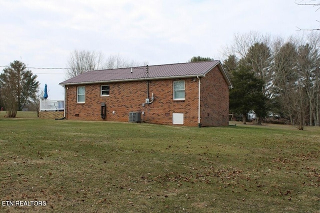 rear view of property with a yard and cooling unit