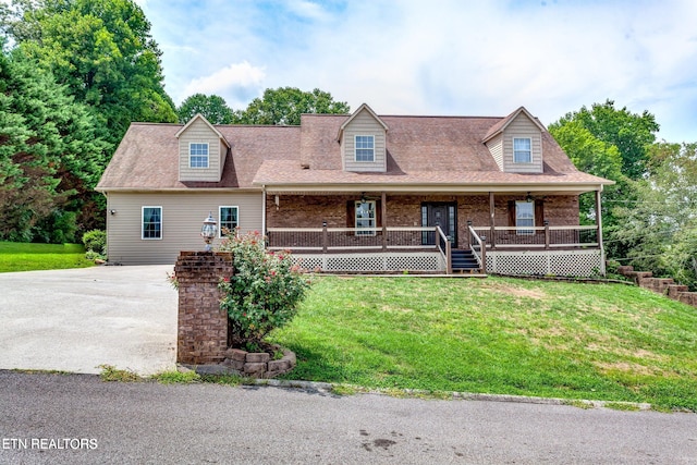 cape cod house featuring a front lawn and a porch