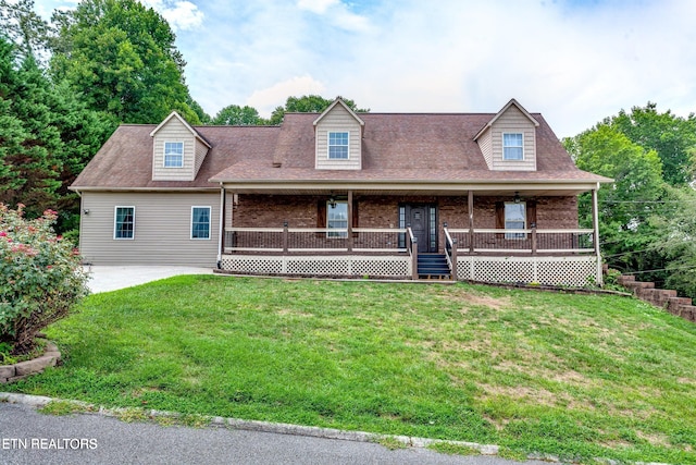 cape cod house featuring covered porch and a front lawn