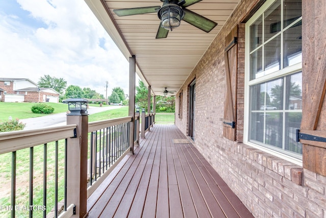 wooden terrace featuring a porch and ceiling fan