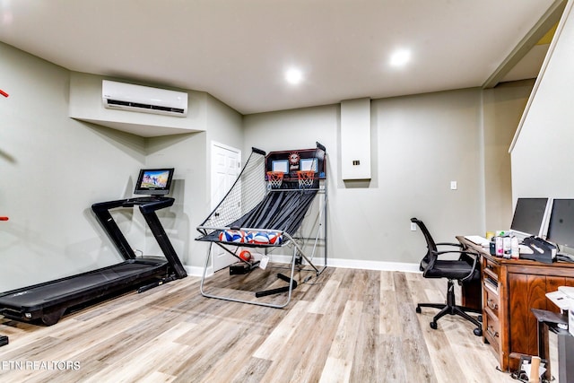 office featuring a wall unit AC and light hardwood / wood-style flooring