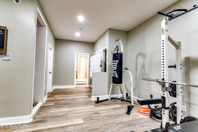 workout area with light hardwood / wood-style floors