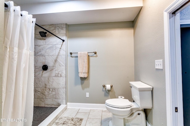 bathroom featuring tile patterned flooring, a shower with curtain, and toilet