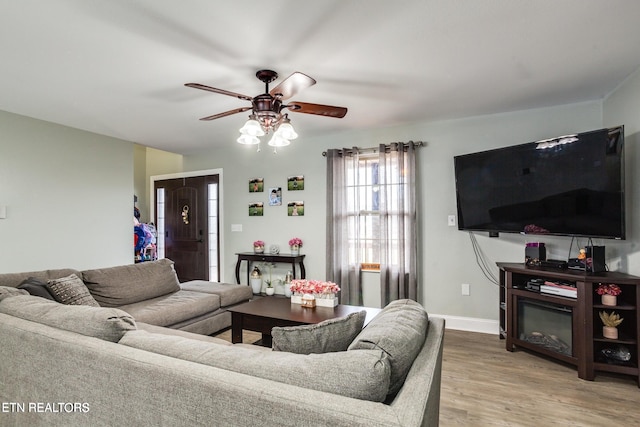 living room with hardwood / wood-style flooring and ceiling fan