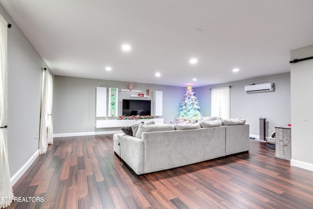 living room featuring plenty of natural light, dark wood-type flooring, and a wall mounted AC