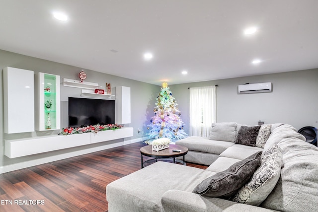 living room with dark hardwood / wood-style flooring and an AC wall unit