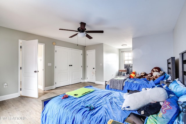 bedroom with ceiling fan and hardwood / wood-style flooring