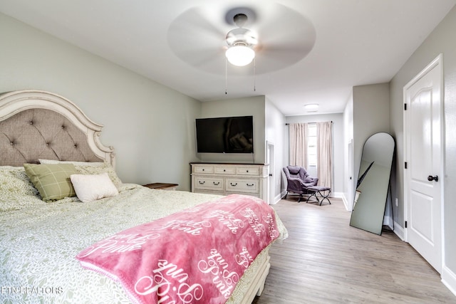 bedroom with light hardwood / wood-style floors and ceiling fan