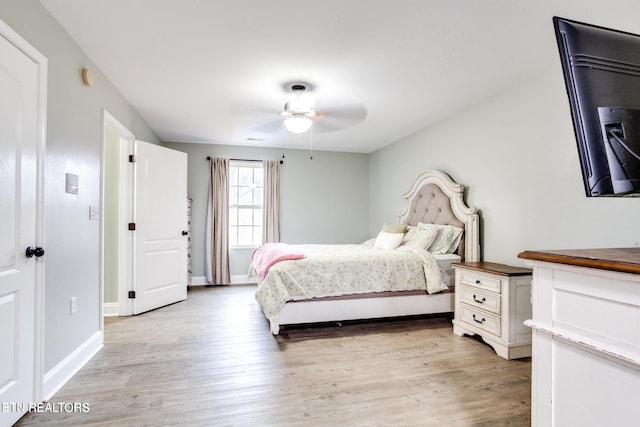 bedroom with ceiling fan and light hardwood / wood-style flooring