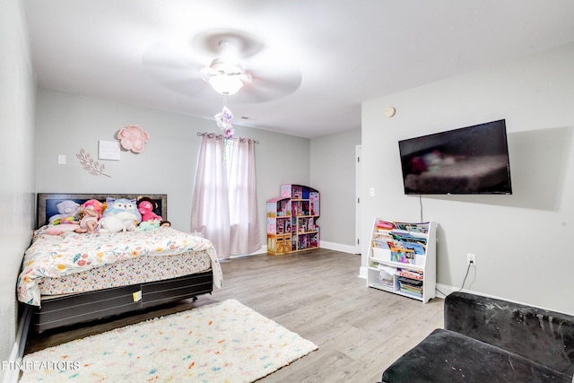 bedroom with ceiling fan and light hardwood / wood-style floors