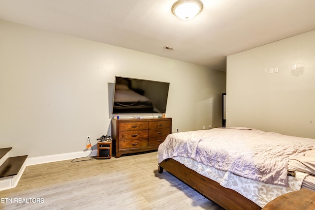 bedroom with hardwood / wood-style floors