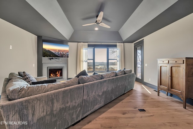 living room featuring hardwood / wood-style floors, vaulted ceiling, and ceiling fan