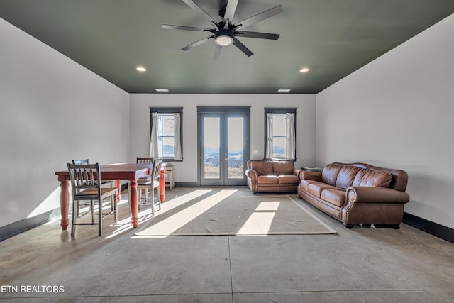 living room featuring ceiling fan and french doors