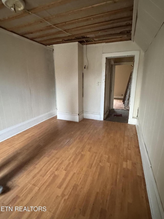 unfurnished room with hardwood / wood-style flooring